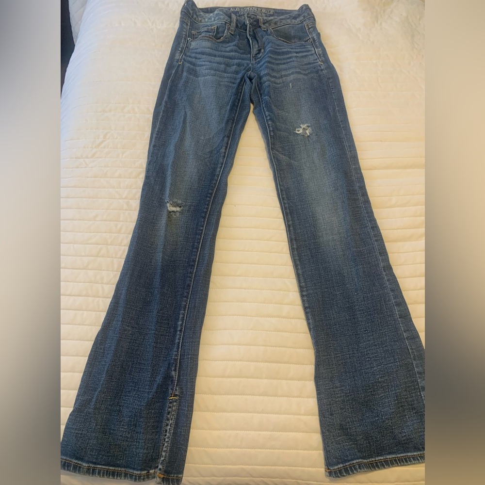 Women’s American Eagle distressed bootcut jeans with slit bootcut bottom.